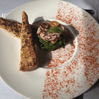 Gourmet seafood salad with toasted bread slices.