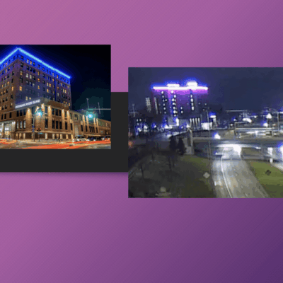 Two buildings lit up at night.
