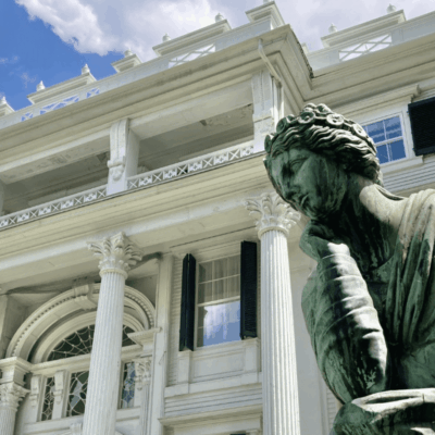 Statue in front of historic building facade.