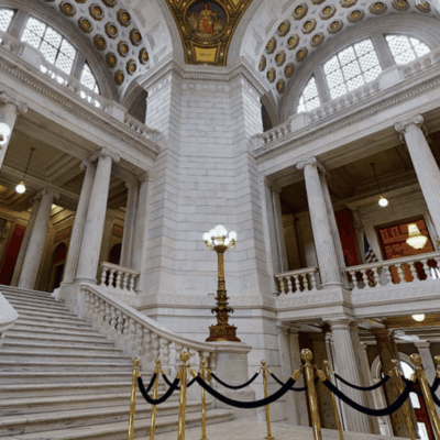 Grand marble staircase with ornate columns.
