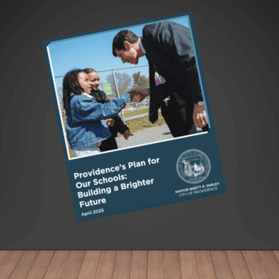 Man and students shaking hands outdoors.