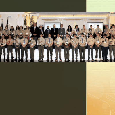 Group of scouts posing in formal setting.