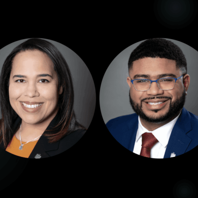 Two people smiling in professional attire.