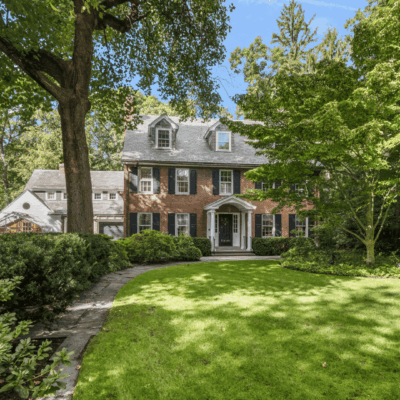Brick house with lush green front yard.