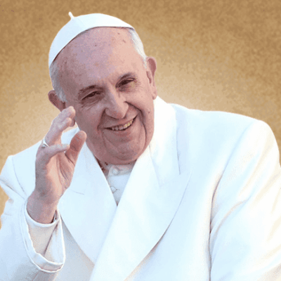 Man in white robe smiling, raising hand.