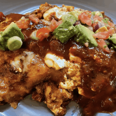 Mexican dish with sauce and avocado topping.