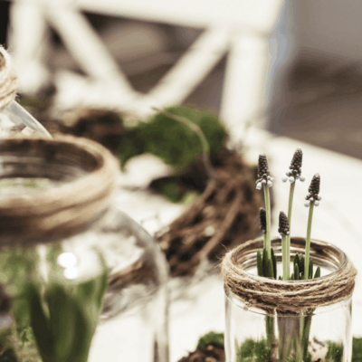 Glass jars with small flowers and twine.