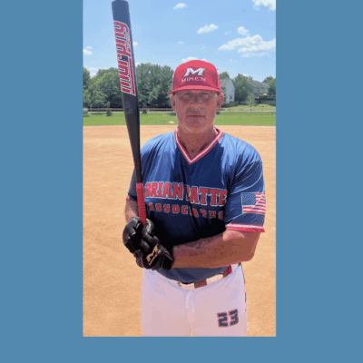 Baseball player holding a bat on field.