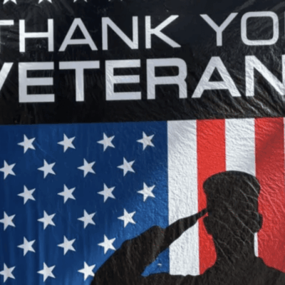 Thank You Veterans" banner with saluting silhouette.