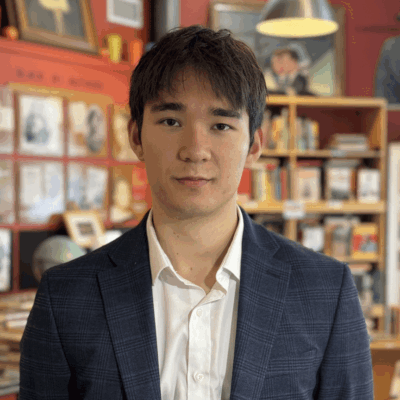 Man in a suit in a bookstore.