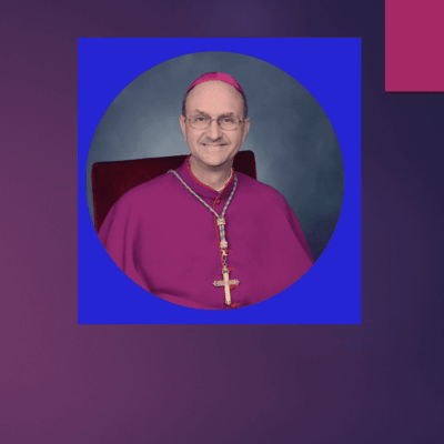 Man in religious attire with cross necklace.