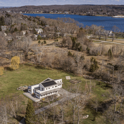 A house with a large yard and trees in the background
