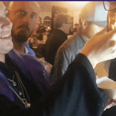 A group of people in a room with scissors.