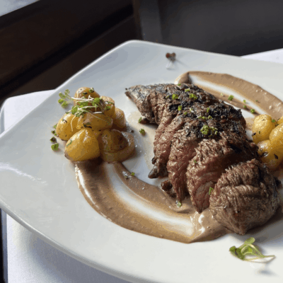 A plate of food with meat and sauce on it.