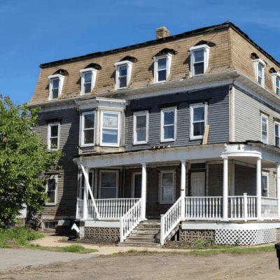 A large two story house with white railings.