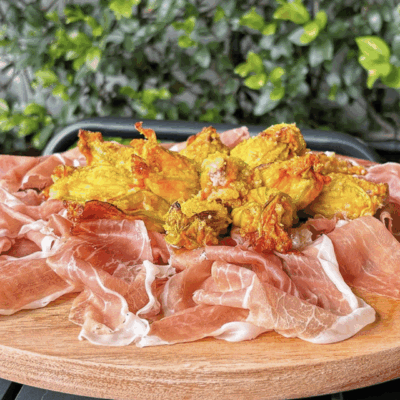 Appetizing platter of prosciutto and golden fried fritters.