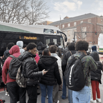 Students boarding a school bus on a chilly day.