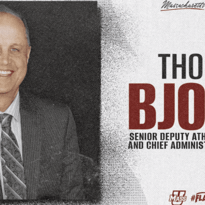 Portrait of a senior deputy athletic director in a suit.