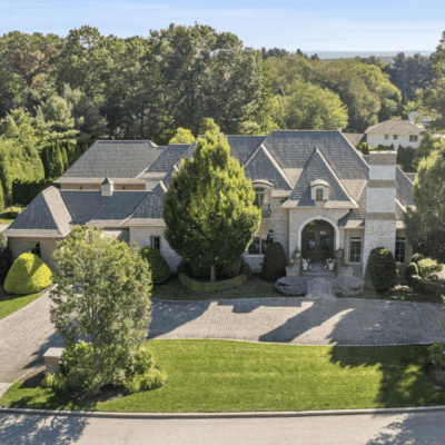 Large suburban house with multiple gables and a spacious driveway.