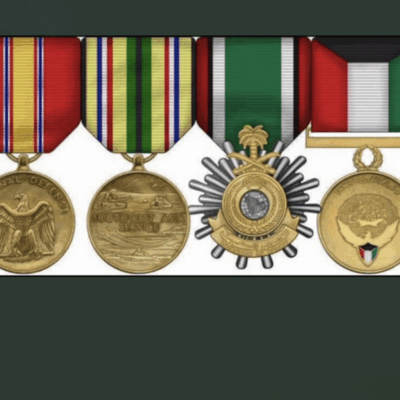 A display of five military medals with colorful ribbons.