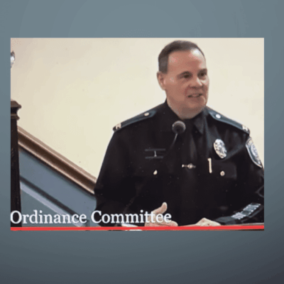 Police officer speaking during Ordinance Committee meeting.
