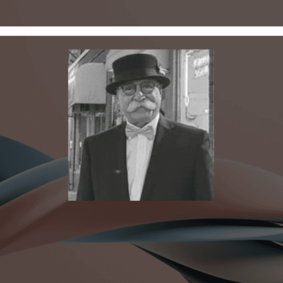 An elderly man with a mustache wearing a black hat and bow tie.