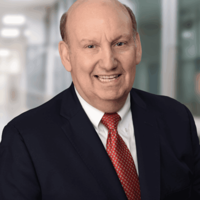 Professional businessman in a suit smiling indoors.