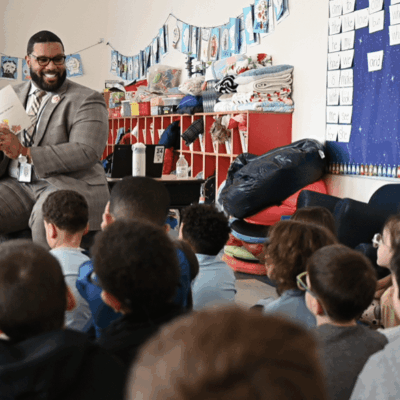Teacher engaging young students in a classroom storytime session.