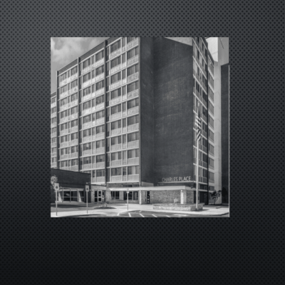 Black and white photo of a multi-story building with modernist architecture.