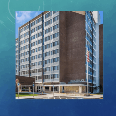 Modern multi-story office building with glass windows and brick facade.