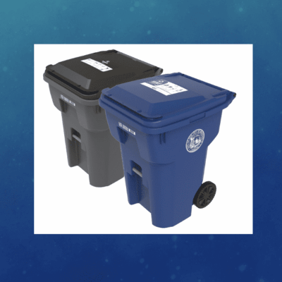 Two wheeled trash bins, one black and one blue, for waste and recycling.