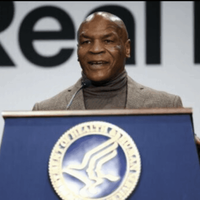 Man speaking at a podium with a health department seal.