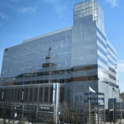 Modern glass office building reflecting the sky.