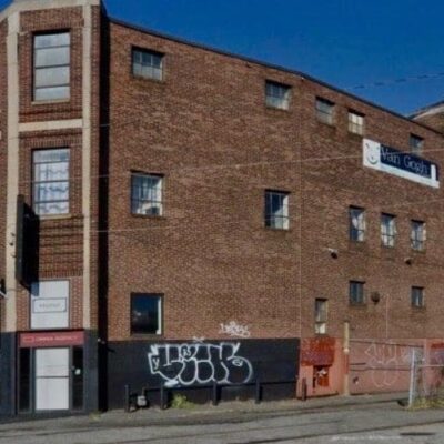 An old brick building with graffiti on it.