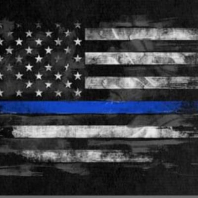 A thin blue line american flag on a black background.
