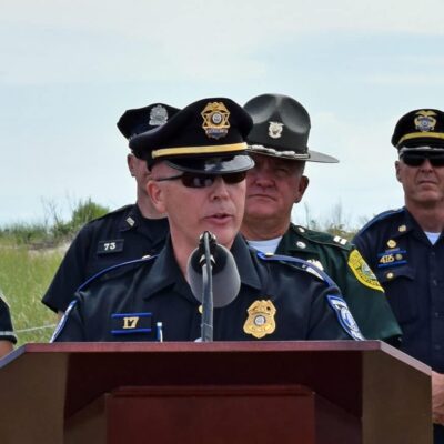 A group of police officers standing at a podium.