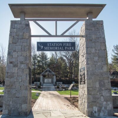 The entrance to a cemetery with a stone archway.