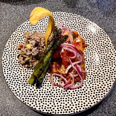 A plate with asparagus and rice on it.