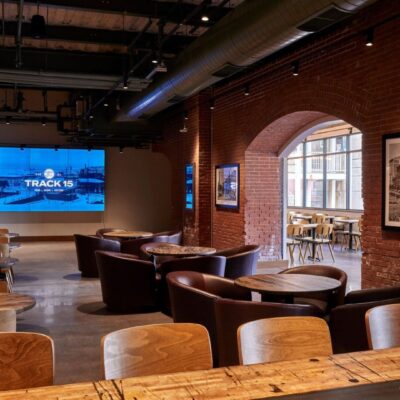 Industrial-style cafe with brick walls and seating.