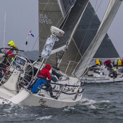 A group of Ida Lewis sailboats in the water.