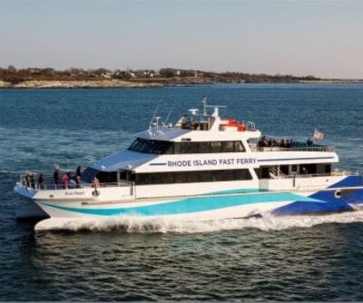 A blue and white ferry traveling on the water.