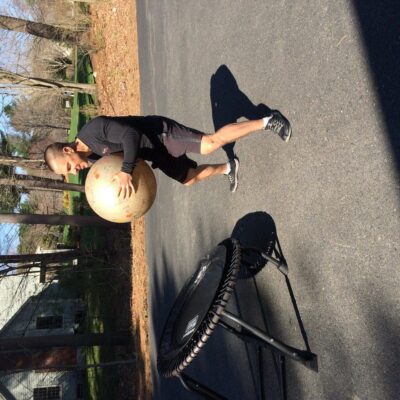 A man doing a squat on a trampoline.