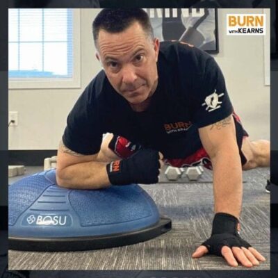 A man is using an exercise ball for self-defense while lying down.