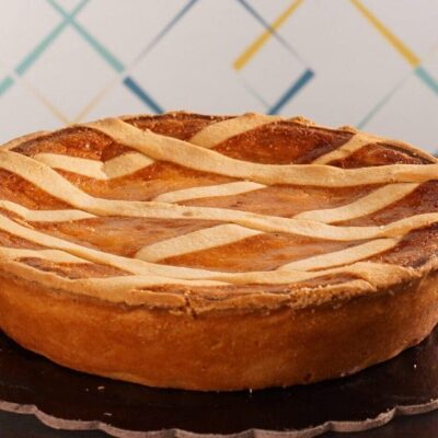 Round pie with lattice crust on table.