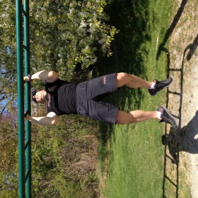 A man doing pull ups on a pull up bar.