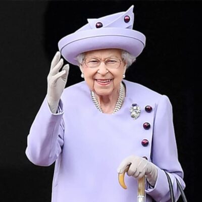 Queen elizabeth iii in a purple coat and hat.