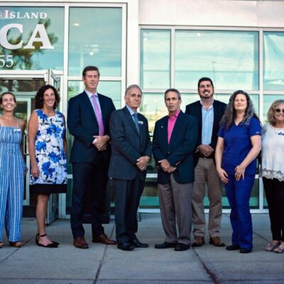 A group of people standing in front of the RISPCA building.