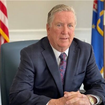 A man in a suit sitting at a desk.