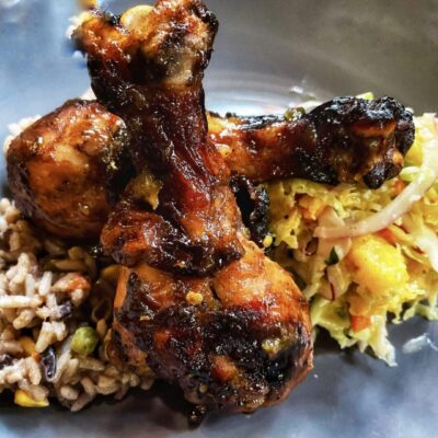 A plate with chicken and rice on it.