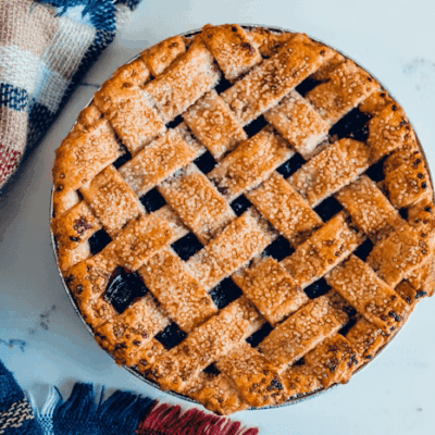 A freshly baked lattice-top pie with a golden crust.